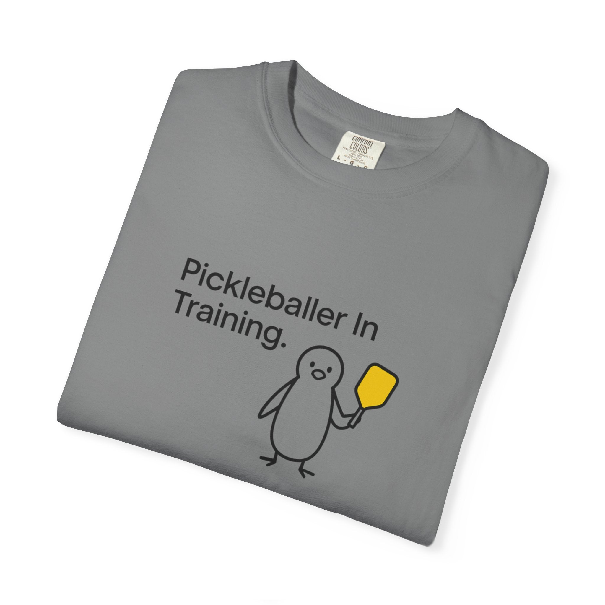 Pickleballer in Training T-Shirt | Cute Penguin Holding Paddle Design